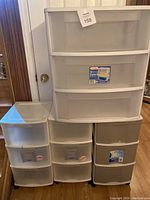 Four plastic storage drawer units grouped together showing varying sizes and colors.