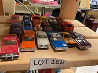 Lot of 14 die cast cars arranged on wooden shelf, including vintage style cars and a red service tow truck.