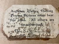 Close-up photo of a label on the back of the framed print stating it is an authentic Wallace Nutting process picture with number 8161