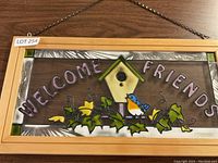 Full view of framed glass hanging with 'WELCOME FRIENDS' text, birdhouse, bluebird, and ivy detail.