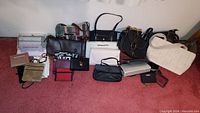 Wide shot of all purses, wallets, and change purses on floor showing quantity and variety