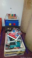 Photo of Little Tykes tool bench set along with boxed microscope and assorted games and cards