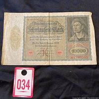 Front view of the 1922 Reichsbanknote 10,000 Mark showing the full banknote with serial number H1195052 and printed date January 19, 1922, with visible creases and wear.