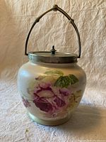Full view of antique W&R Carlton Ware biscuit barrel with floral decoration and metal handle.