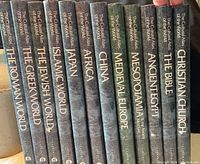 Photo showing the spines of the 12 books in the set, each titled under The Cultural Atlas of the World by Stonehenge.