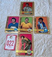 Six 1972/73 OPC hockey cards featuring Phil Esposito, Doug Wilson, Rogatien Vachon, Gilbert Perreault, Reg Leach in team uniforms, plus a numbered placeholder card 022.