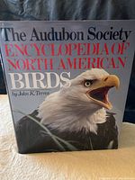 Front cover of 'The Audubon Society Encyclopedia of North American Birds' featuring an eagle and title text.