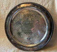 Full view of the round silver plated presentation tray showing farming themed engraving and beaded edge rim.