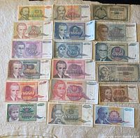 Top-down photo of 18 Yugoslavian banknotes showing multiple denominations and portraits of historical figures.