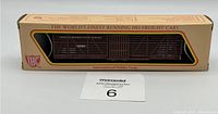 Image of the HO scale stock car in its original box showing brown car in window with 'The World's Finest Running HO Freight Cars' text on box.
