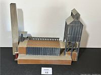 Front and side view of the HO scale industrial factory model featuring a tall chimney and elevated silo structure.