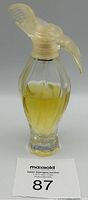 Front view of L'Air du Temps perfume bottle with yellow perfume and frosted dove-shaped cap