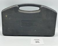 Closed black plastic carrying case with textured surface and embedded brand name.