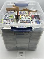 Clear plastic tote filled with neatly stacked sports cards visible from the side, showing thickness of the collection.