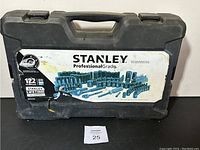 Closed black hard plastic carrying case with Stanley Professional Grade label showing 122 piece set with Lifetime Warranty.