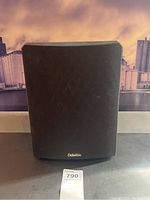 Front view with grille installed, showing Definitive logo on fabric grille.