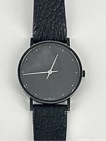 Front close-up of watch face showing dial, markers and hands