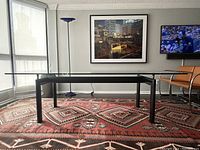 Front view of full table showing glass top and steel base