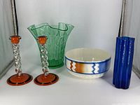 Front view of entire lot showing five decorative pieces on white surface