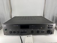 Front view of black NAD 7155 showing full front panel layout and chassis.