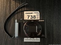 Front view with lens closed and wrist strap visible