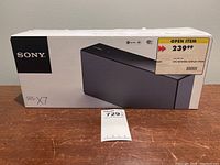 Front view of the Sony SRS-X7 speaker box showing the product image and price tag