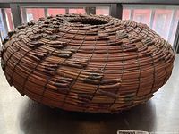 Side view of round basket showing overall shape and binding pattern