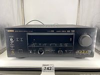 Front view of Yamaha AV receiver showing overall condition with control knobs, buttons, and display.