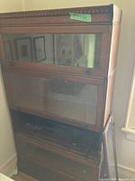 Front view of stacked four-piece oak bookcase with glass doors