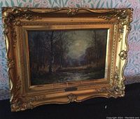 Overall view of oil painting in ornate gilt wood frame.