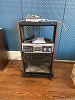 Full front view of rack containing all three components and items stored on top shelf.