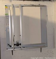 Full view of Speed-Mat mat cutter mounted against a wall, showing aluminum frame and sliding assemblies.