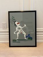 Framed limited edition print showing the indigenous style figure with signature and embossing visible.