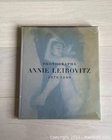 Closed hardcover book with dust jacket showing the title and a cover photograph of a nude embrace.