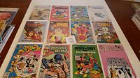 Top-down photo of 12 cartoon-related independent comics arranged in a grid. Large variety of titles and characters visible.