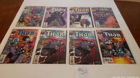 Full view of all 8 The Mighty Thor comics laid out on a flat surface showing front covers in mint condition.