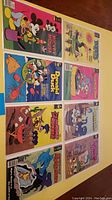 Full lot of 8 comics laid out on a surface, showing front covers with characters like Mickey Mouse, Donald Duck, and others.