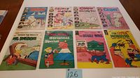 Eight vintage cartoon comic books laid out showing front covers including Casper, Dennis the Menace, Audrey and Melvin.