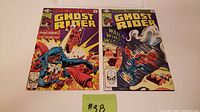 Both Ghost Rider comic books issues 54 and 56 placed side by side showing full front covers for overview of items in the lot.