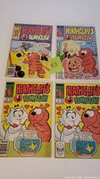 Four Heathcliff's Funhouse comics with cover art showing characters and Halloween and fishbowl scenes.