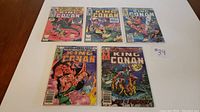 Five King Conan comics laid out on a wooden surface with a handwritten note '#39'.