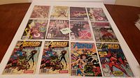 Full lot of 12 Marvel comics arranged on table showing all front covers.