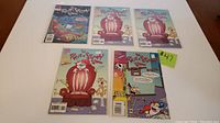 Five Ren & Stimpy Show comic books displayed, including three copies of issue 25, issue 7, and a special edition.