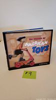 Front cover of the book 'The Wonder of American Toys 1920-1950' showing a child on a red scooter toy