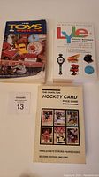 Front covers of 1994 Toys & Prices, 2004 Lyle Official Antiques Review, and 1991/92 Charlton Hockey Card Price Guide softcover books.