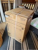 Sealed Danby Diplomat refrigerator box at an angle, showing straps and part of printed graphics