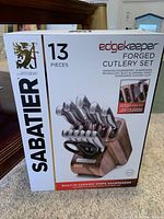 Front view of the Sabatier Edgekeeper forged 13-piece cutlery set box showing the product and built-in ceramic sharpeners.