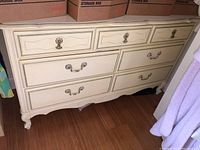 Front view of the painted wood dresser showing all six drawers, decorative drawer fronts, and cabriole legs.
