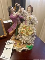 Front angle of Muller Volkstedt Dresden porcelain dancing couple figurine, showing details of male and female figures, base, and hand-painted florals.