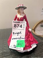 Frontal view showing the figurine with tag and approximate height sticker 7.5 inches.